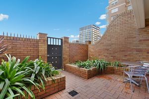 Sandbar Apartment provides a private outdoor courtyard with direct access to Newcastle Beach.